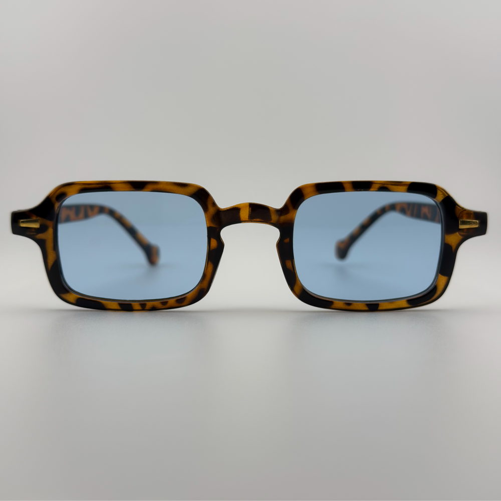 Velra NOYA SYLVESTRE – lunettes de soleil, vue de face : monture écaille chaude et verres bleus pour un contraste élégant.
