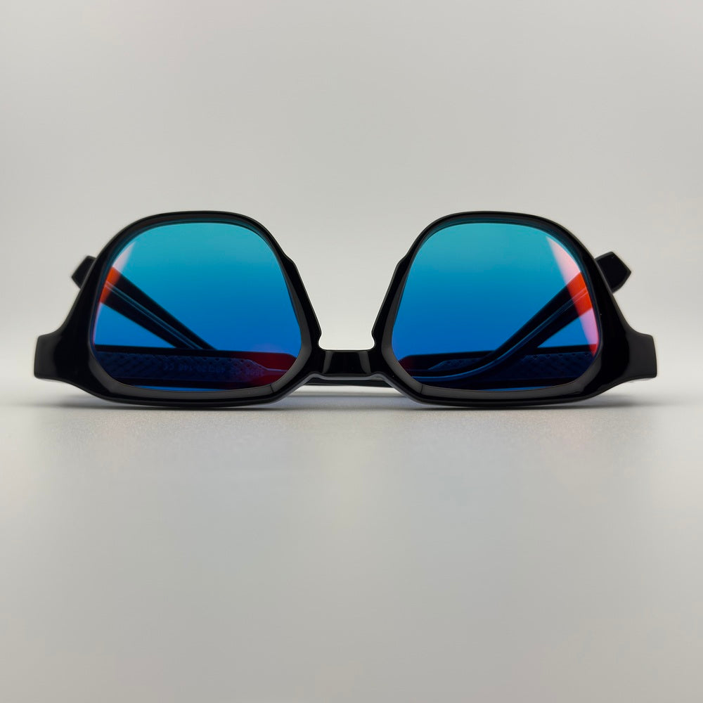 Velra PRISMA SUNSET – lunettes de soleil, vue du dessus : monture noir brillant et verres dégradés rose-bleu avec reflets colorés style coucher de soleil.
